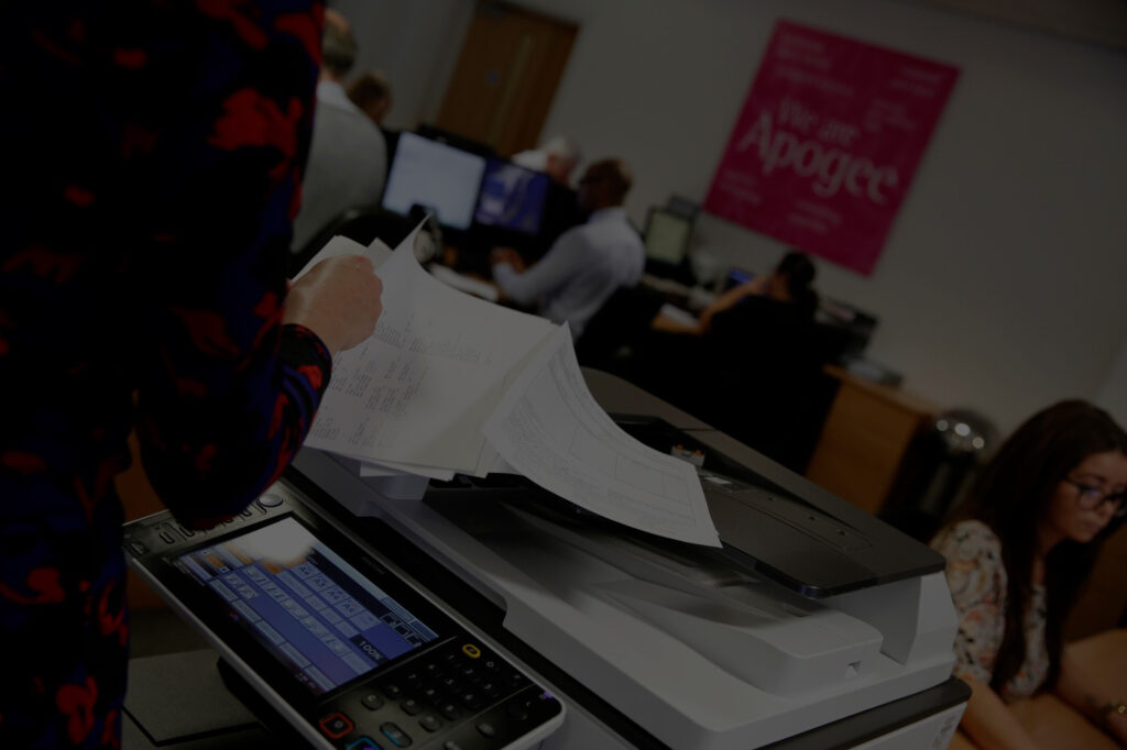 apogee office employees woman using printer photocopier