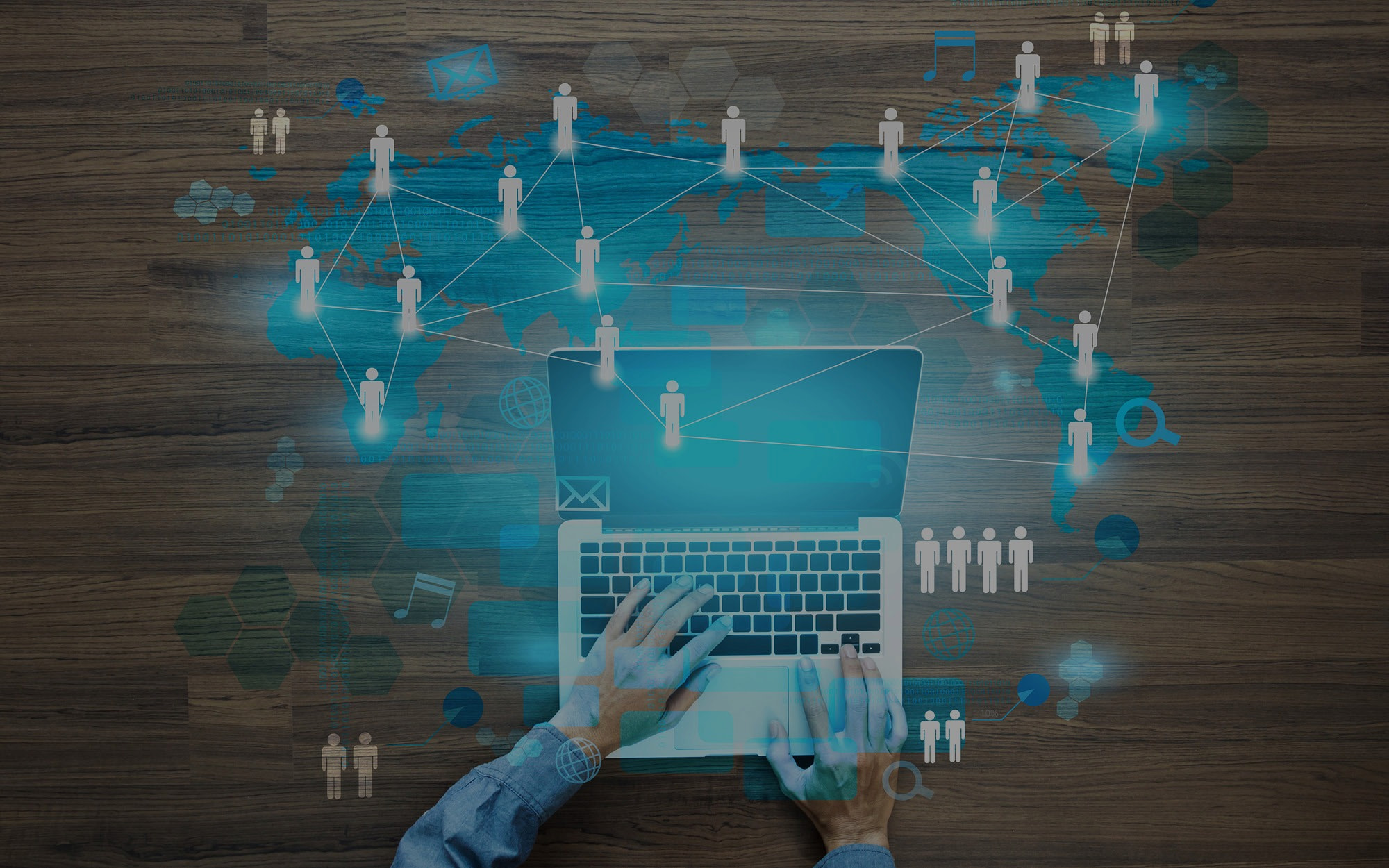 laptop wood table world overlay blue white connected people icons