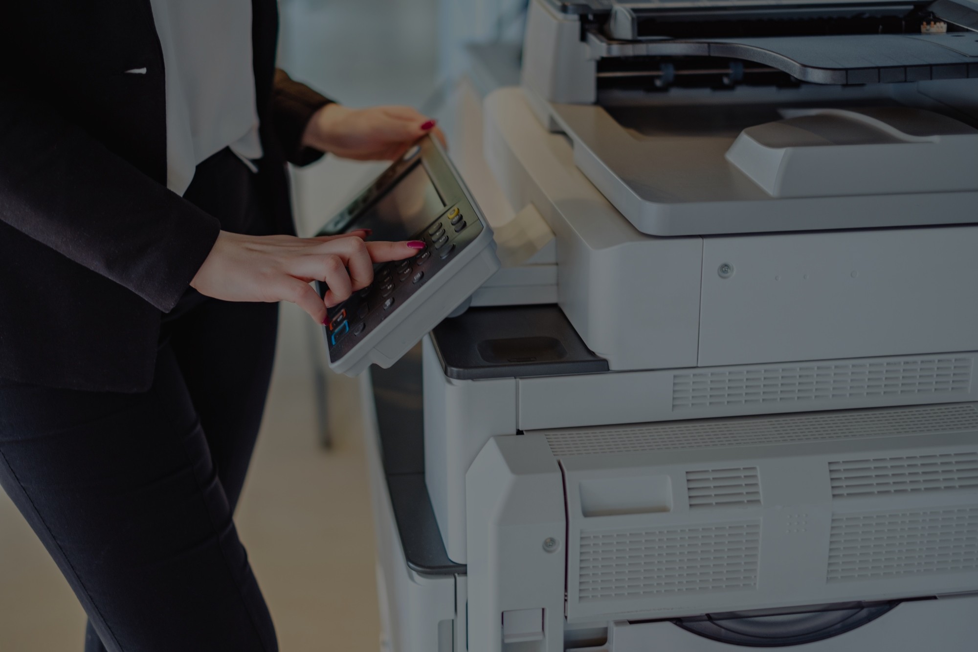 printers can be your company's biggest security risk woman using office printer