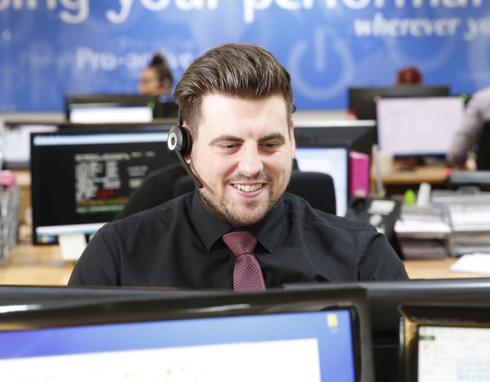apogee employee man at computer technical support call