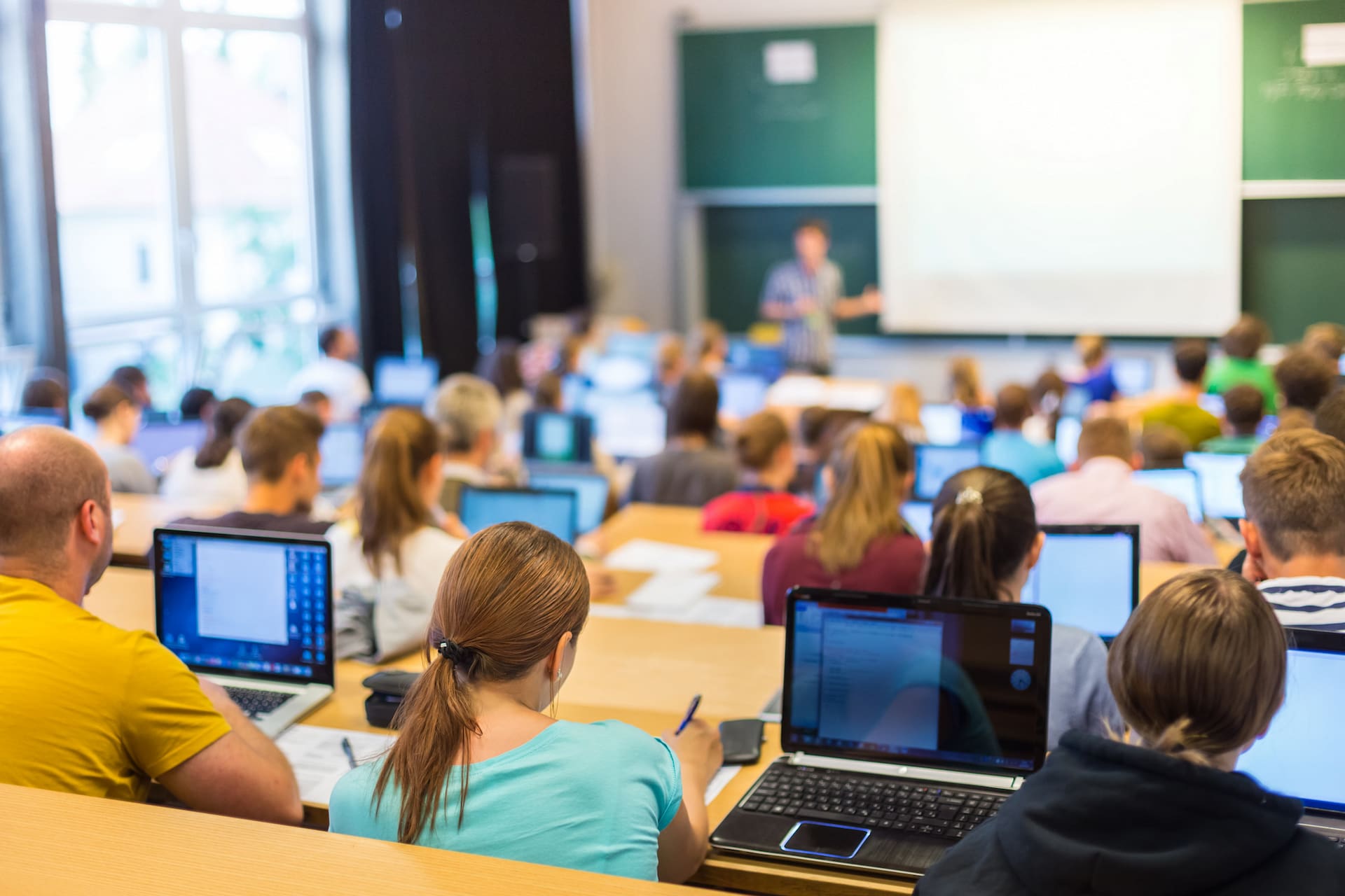 students in university using laptops
