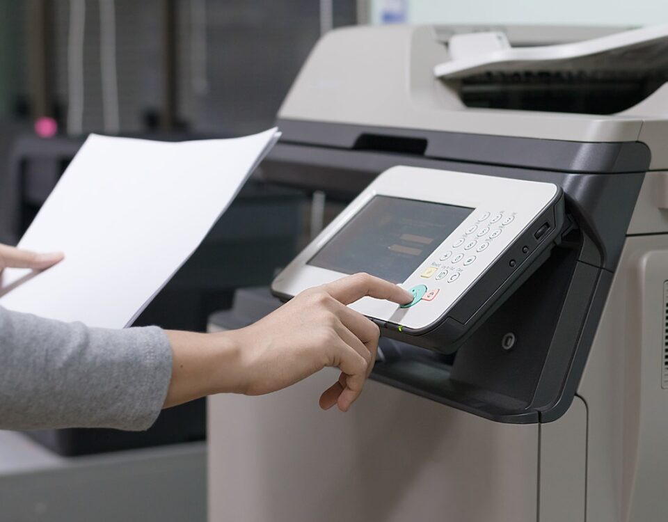 woman using printer photocopier controls