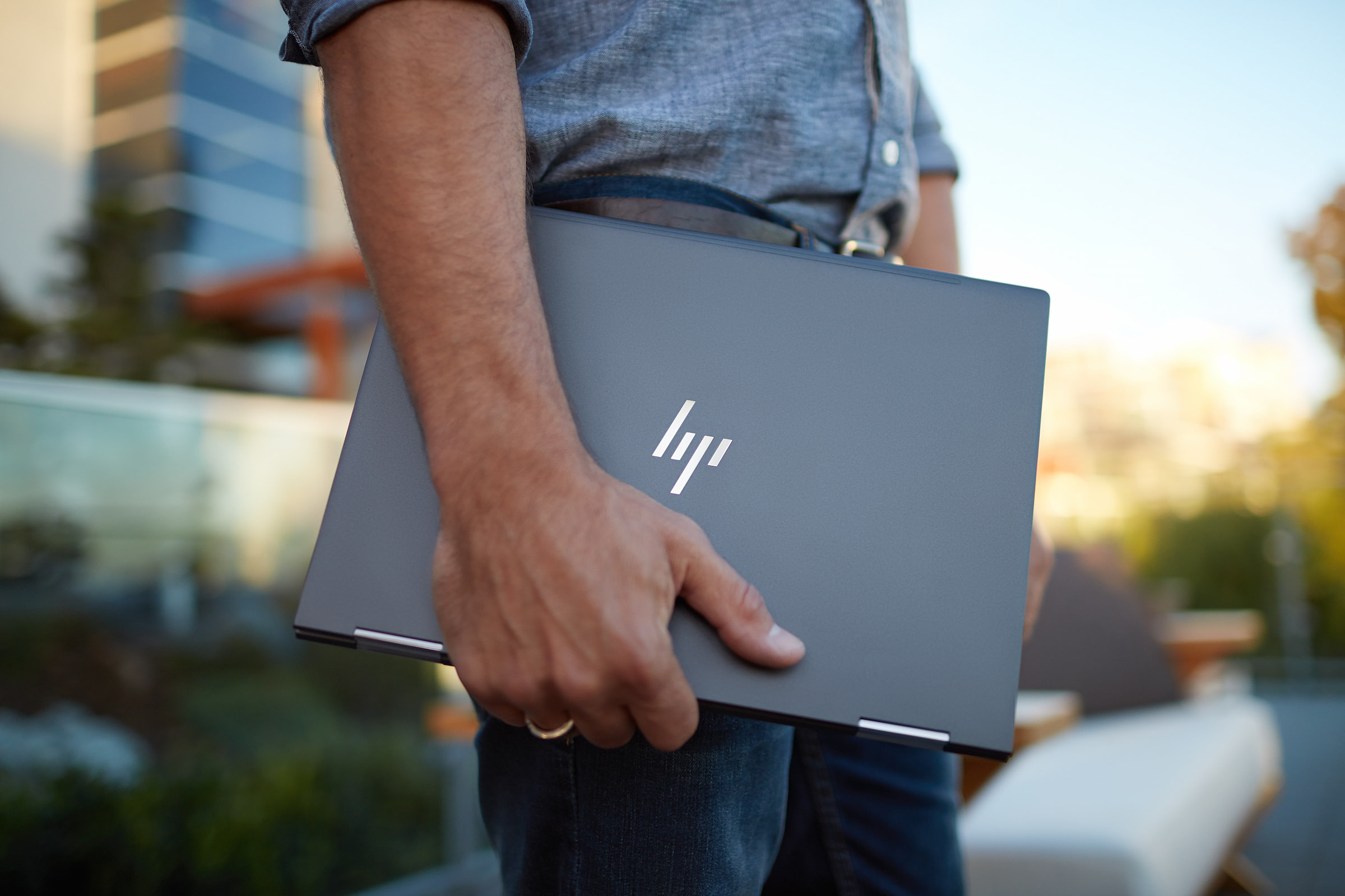 man holding hp laptop dark gray managed it services