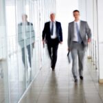 lawyers walking along a corridor in a modern office building