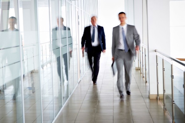 lawyers walking along a corridor in a modern office building