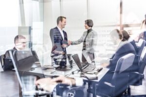 businesspeople in a meeting room behind a window
