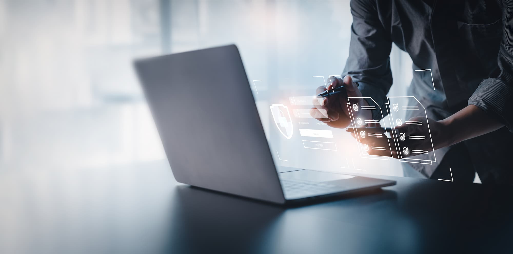 person using laptop on reflective desk