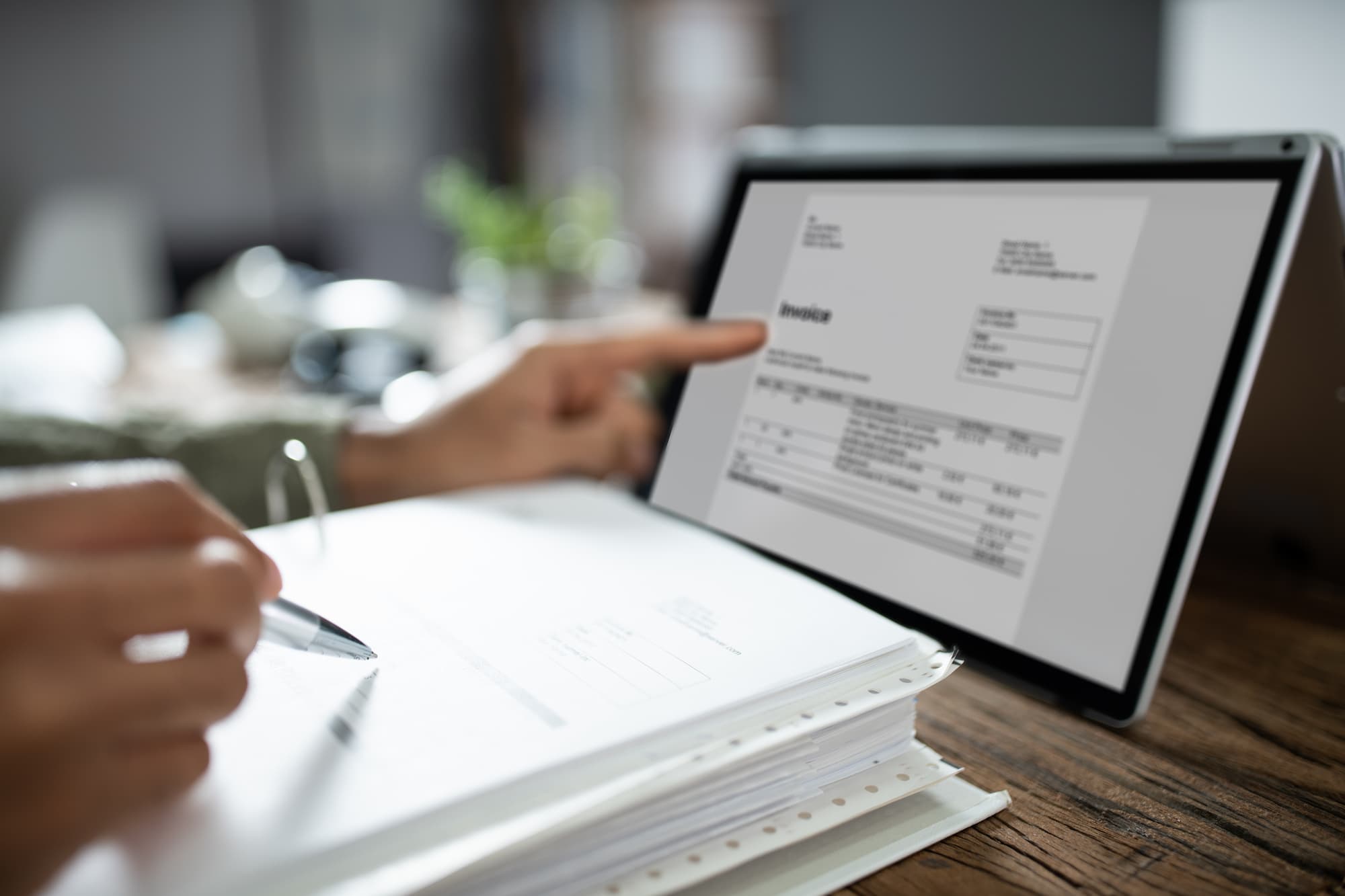 employee with tablet digitising physical documents