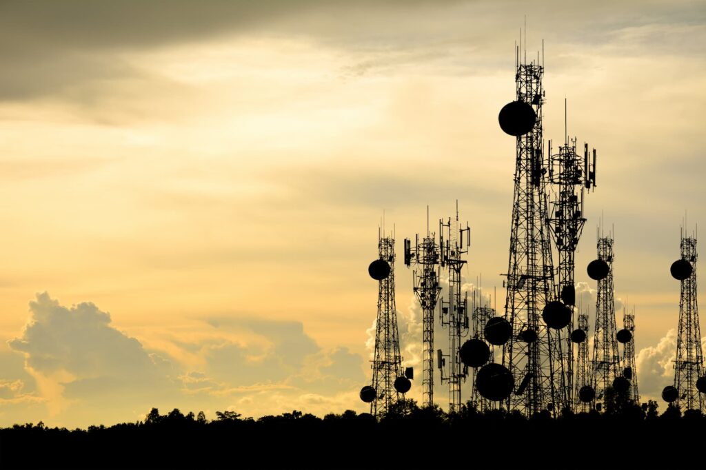 telecoms towers on a hill in the evening