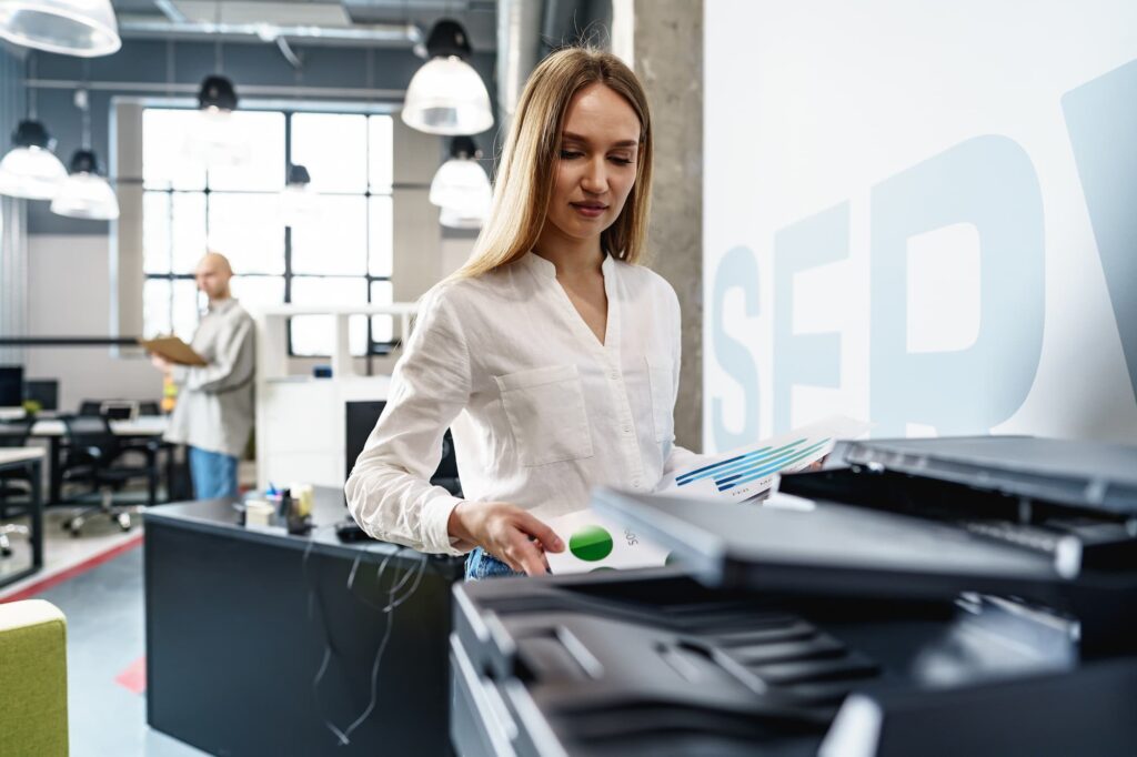 Woman uses printer in office