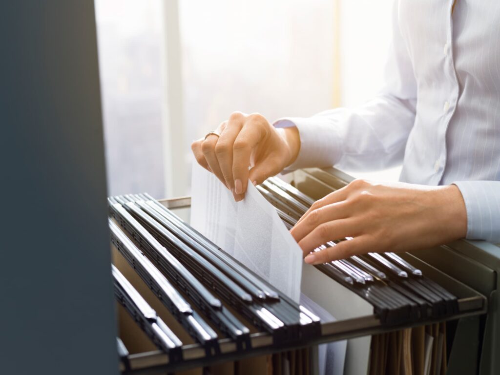 office clerk searching files in the filing cabinet