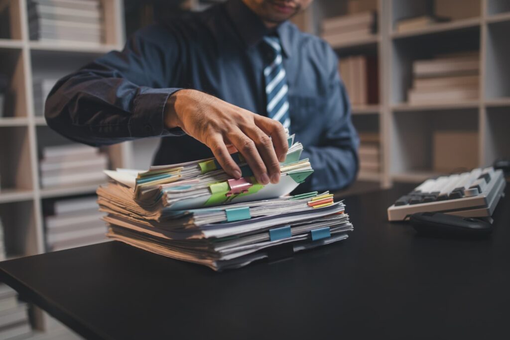 nhs manager rummaging through patient records