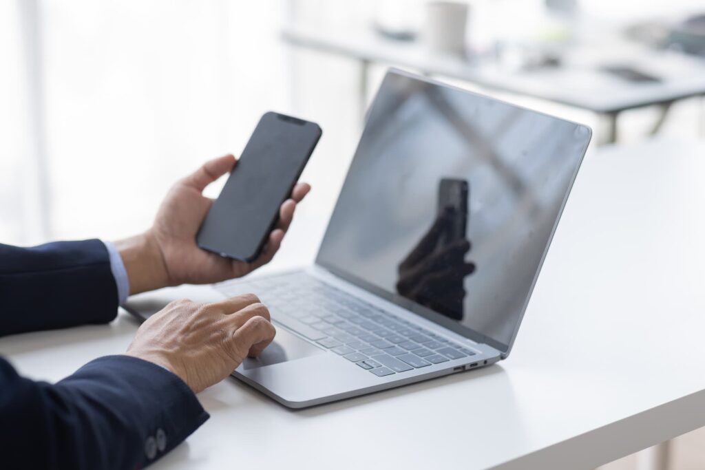 office worker using phone in a hybrid setup