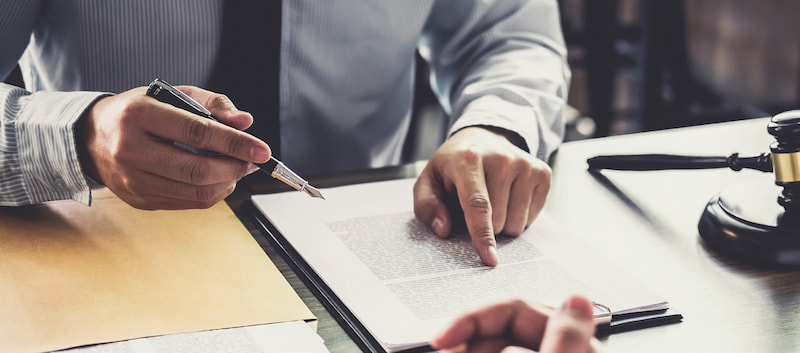 legal documents signing pen at desk