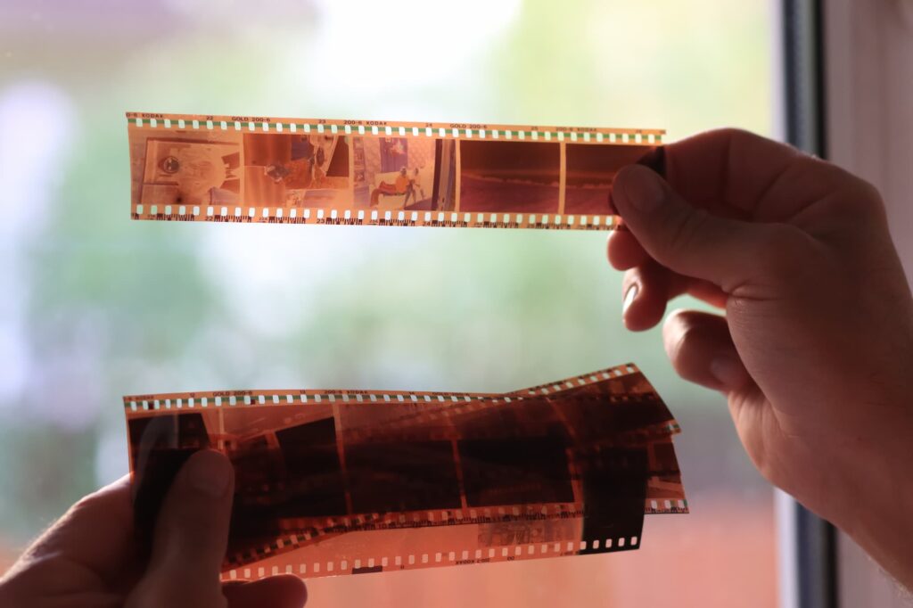 anaolog photography on filmstrip hands holding microfilm