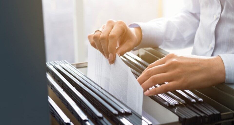 office clerk searching files in the filing cabinet