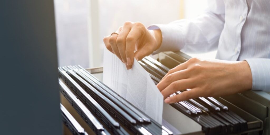 office clerk searching files in the filing cabinet