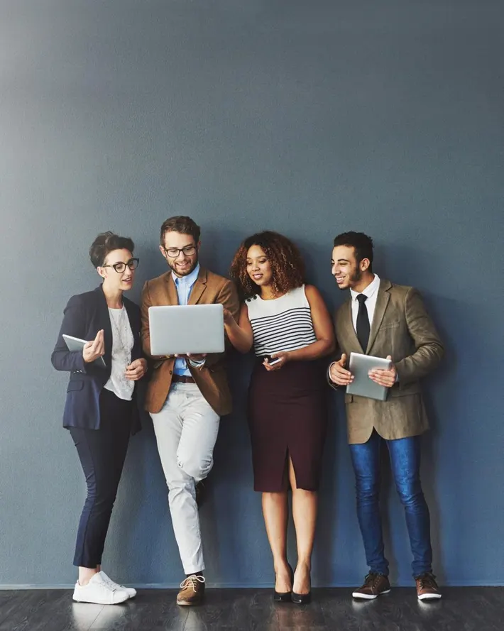 trendy young HR employees against grey background laptop