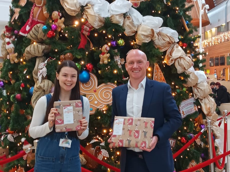 apogee employee delivering presents to alder hey