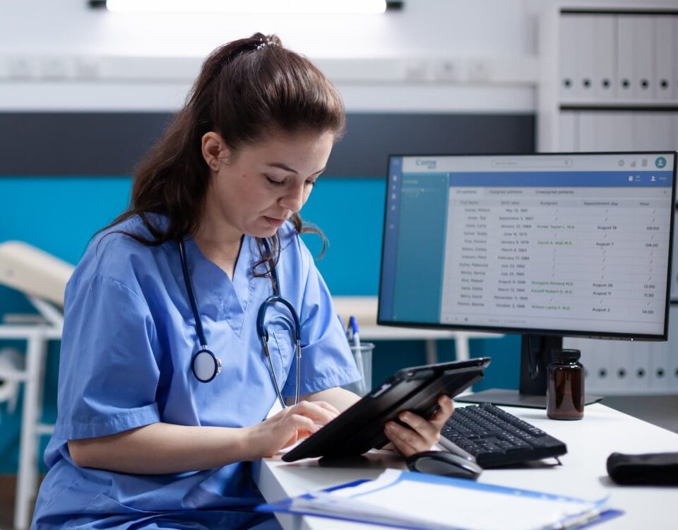 nurse on tablet at computer desk square