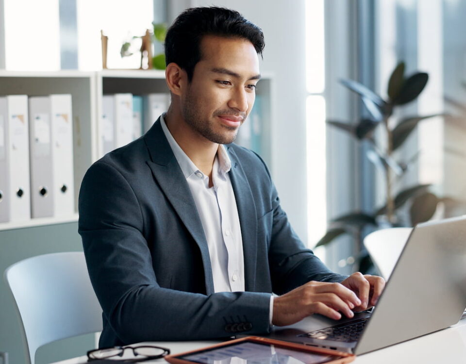man using laptop tablet in white business office