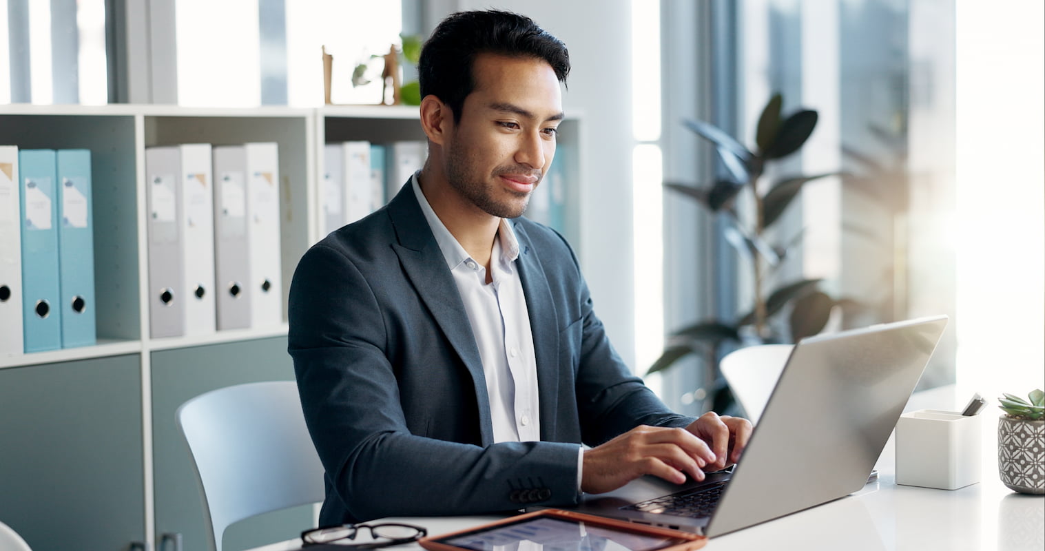 man using laptop tablet in white business office