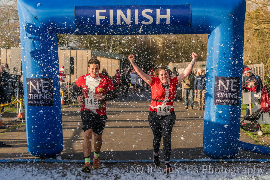 Two participants crossing the finish line
