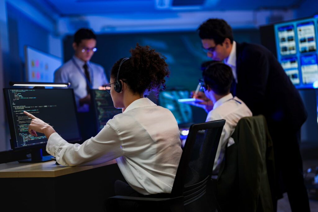 female it support technician pointing at monitor