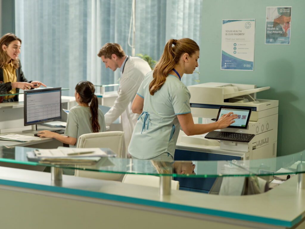 nhs healthcare worker using photocopier printer